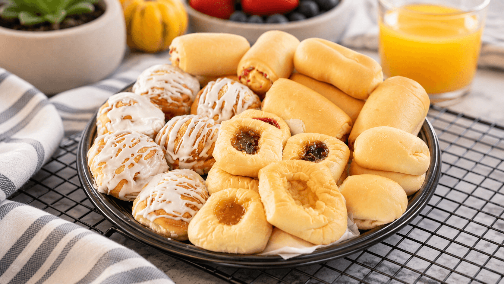 A platter of assorted kolaches with fresh fruit and vegetables