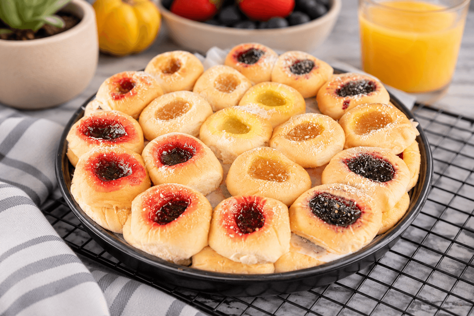 A platter of assorted fruit and cream-cheese kolaches
