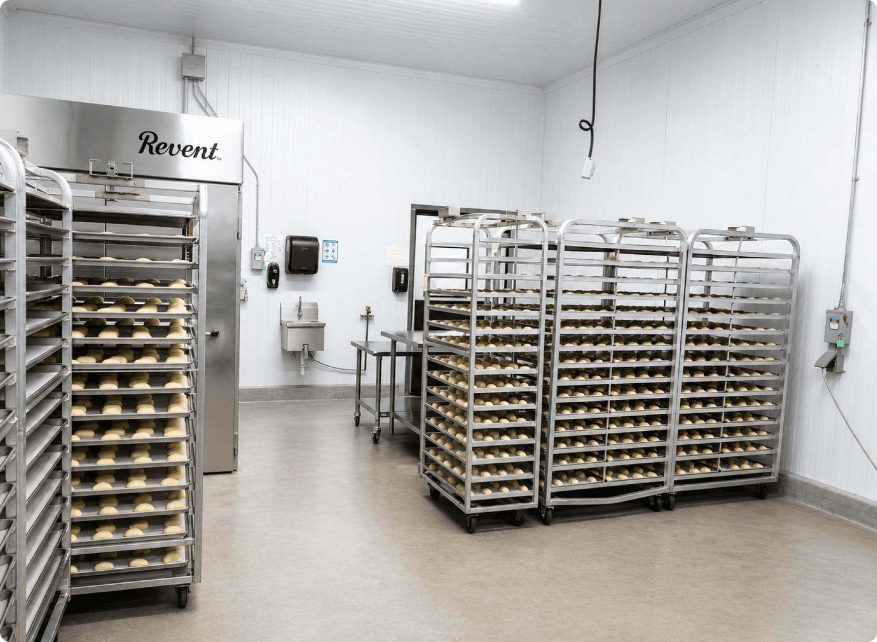 Workers packing kolaches on a commercial production line